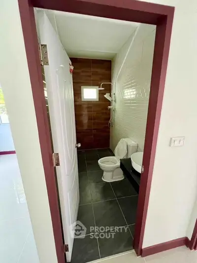 Modern bathroom with sleek design and tiled walls in a contemporary home.