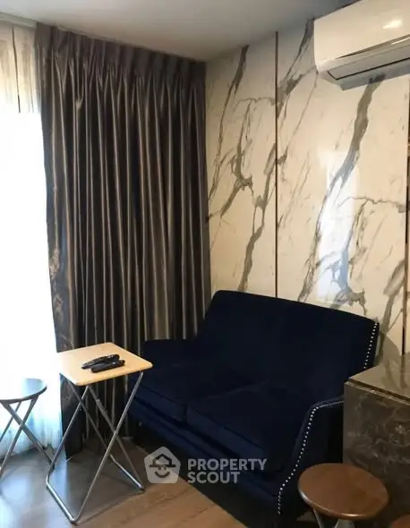 Stylish living room with marble accent wall and modern furniture