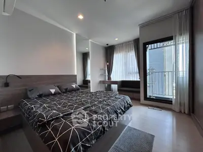 Modern bedroom with stylish decor and balcony access in a luxury apartment.