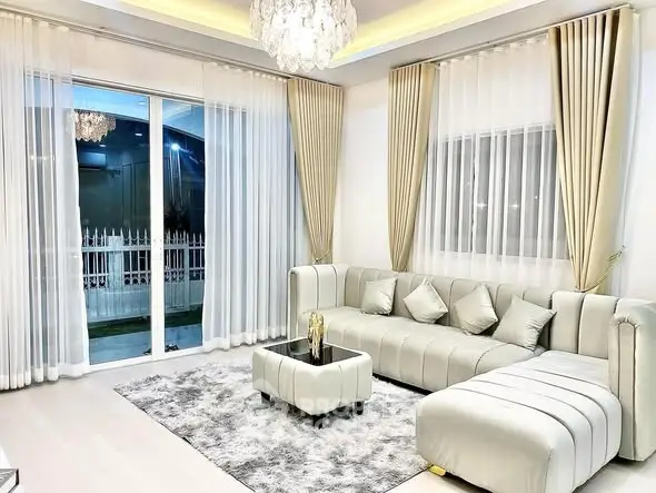 Luxurious living room with elegant chandelier and plush sofa set