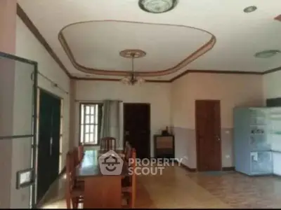 Spacious dining area with elegant ceiling design and ample natural light.