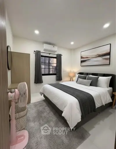 Modern bedroom with stylish decor, featuring a cozy bed, elegant artwork, and ambient lighting.