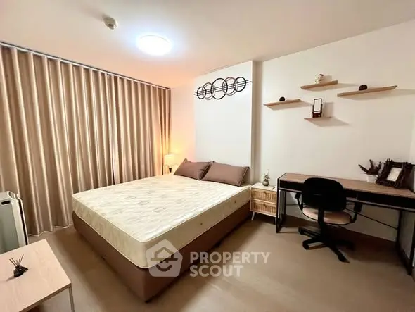Cozy bedroom with modern decor and study area, perfect for relaxation and productivity.