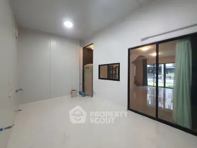Spacious modern interior with sliding glass doors and marble flooring