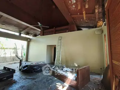 Spacious living room with high ceilings and renovation potential