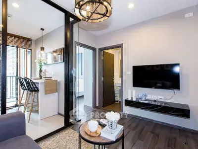 Modern living room with open kitchen and stylish decor in a contemporary apartment.