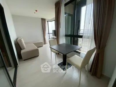 Modern living room with large windows and balcony view in a stylish apartment.