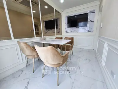 Elegant dining area with marble accents and plush chairs in modern apartment