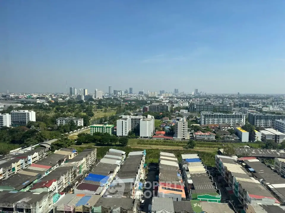 Stunning cityscape view from high-rise building showcasing urban skyline and residential area.