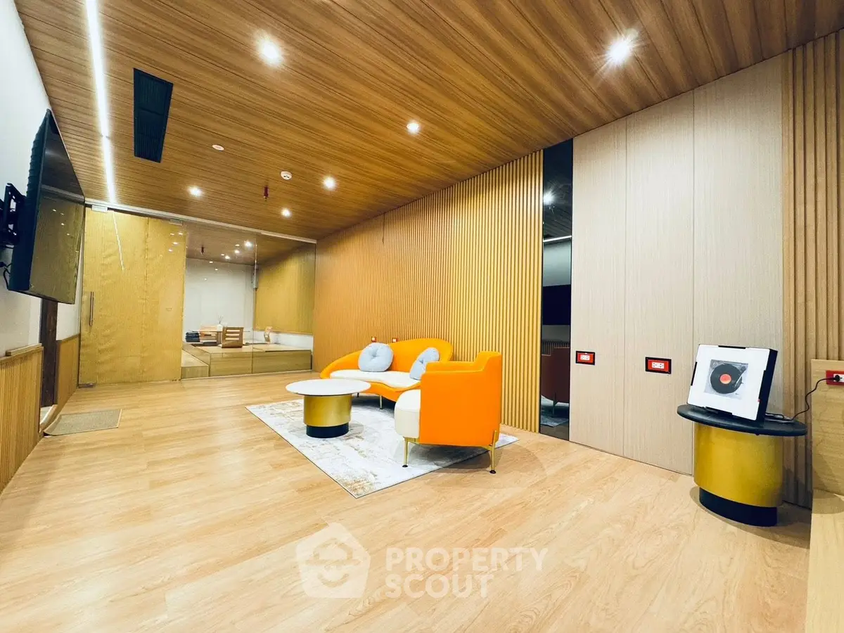 Modern living room with stylish furniture and wooden accents, perfect for contemporary living.