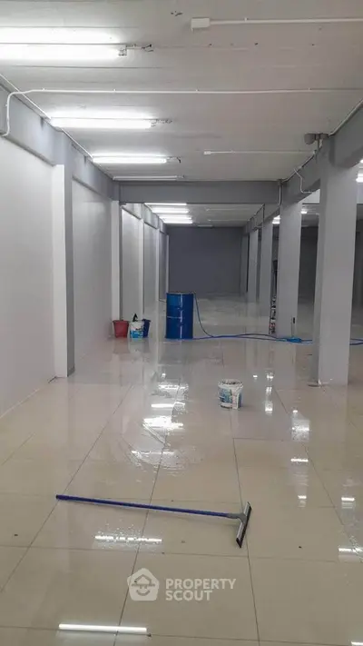 Spacious commercial space with polished floors, ideal for retail or office setup.