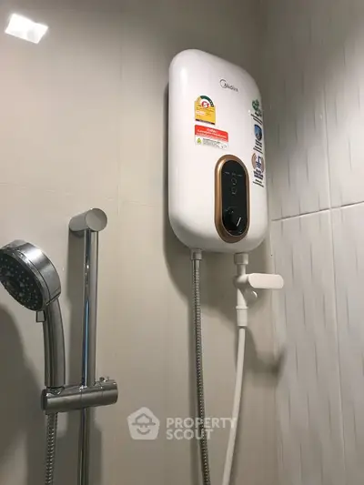Modern bathroom with sleek water heater and shower head, perfect for a contemporary home.