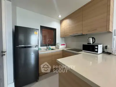 Modern kitchen with sleek appliances and wooden cabinetry, perfect for culinary enthusiasts.