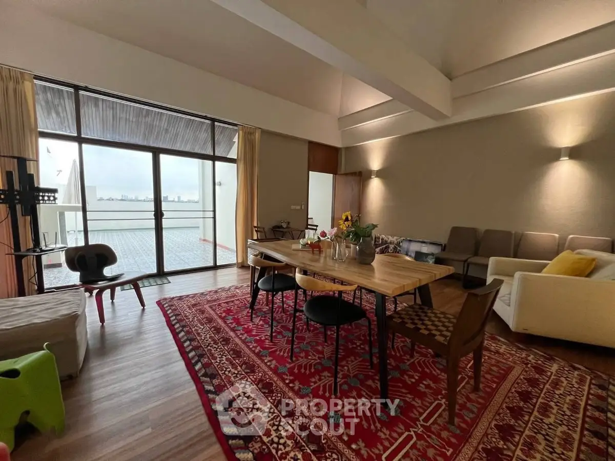 Spacious living room with elegant decor and large balcony offering stunning city views.