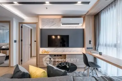 Modern living room with sleek design, featuring a wall-mounted TV, stylish furniture, and ample natural light.