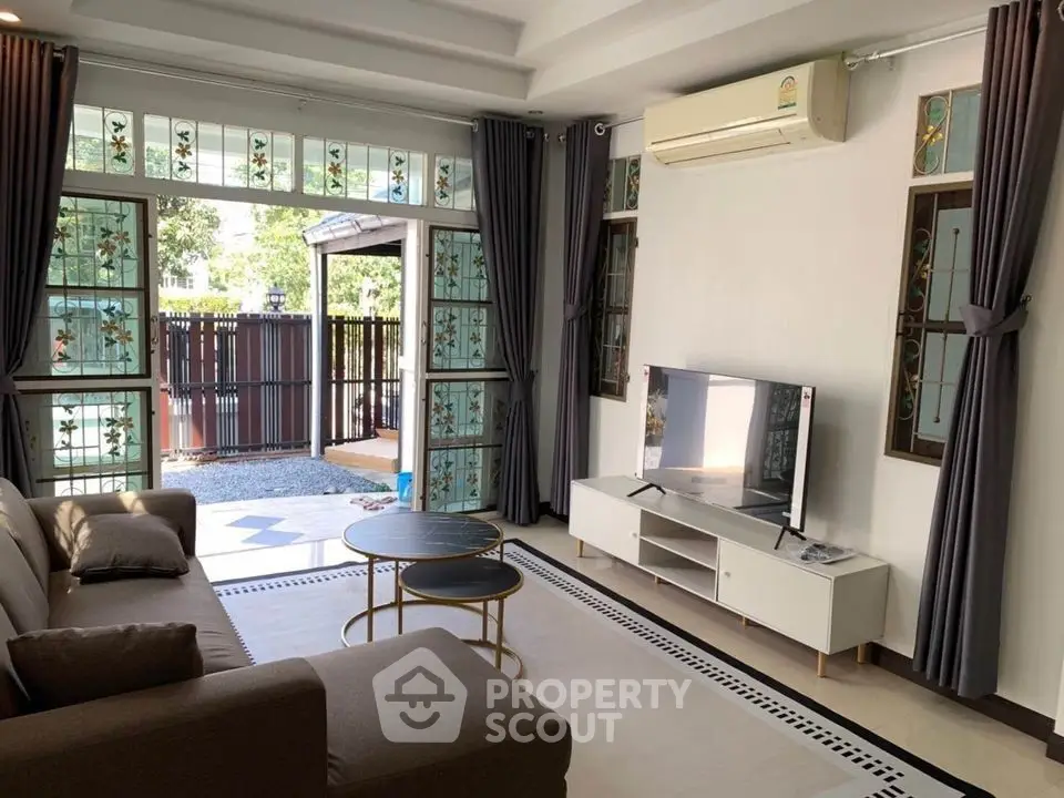 Spacious living room with modern decor and large windows for natural light.