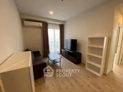 Modern living room with sleek furniture and natural light, perfect for relaxation and entertainment.