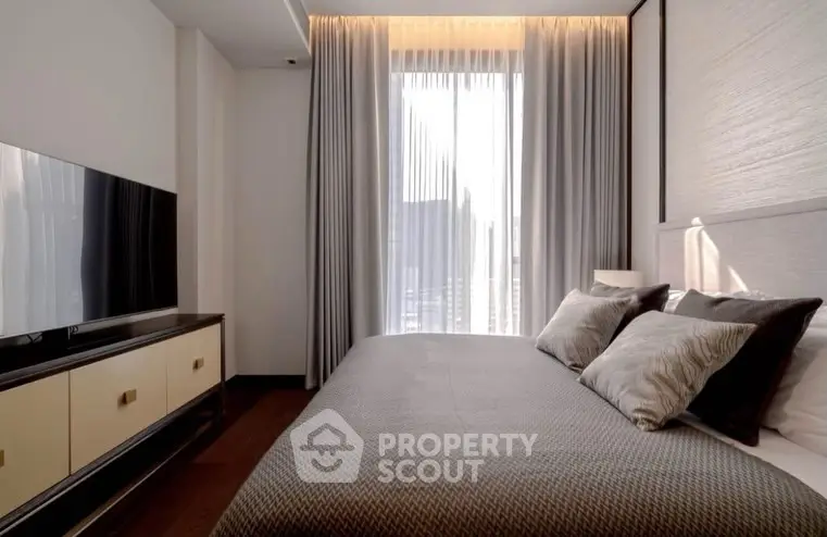 Modern bedroom with sleek design, large window, and stylish decor in a luxury apartment.