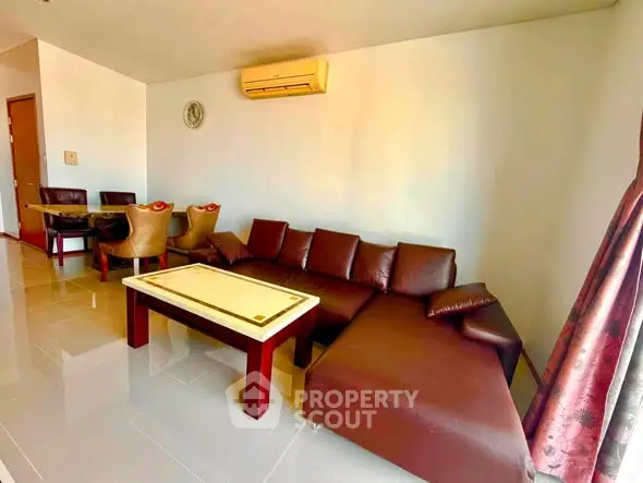 Spacious living room with modern furniture and elegant decor in a stylish apartment.
