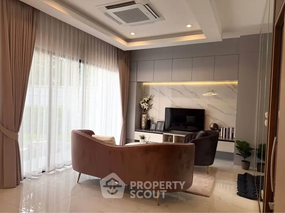 Elegant living room with modern decor, plush seating, and large windows for natural light.