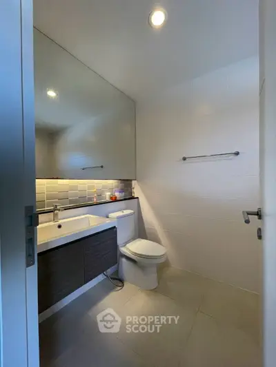 Modern bathroom with sleek fixtures and large mirror
