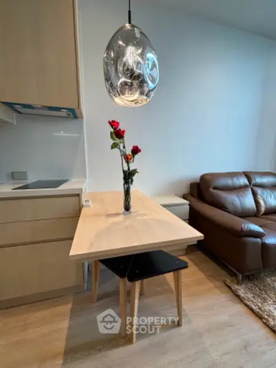 Modern living room with stylish pendant light and cozy leather sofa