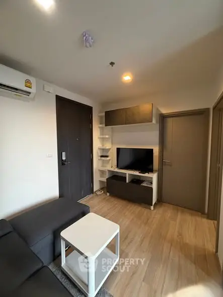 Modern living room with sleek furniture and wooden flooring