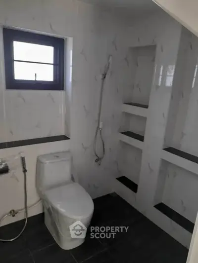 Modern bathroom with sleek design and built-in shelving