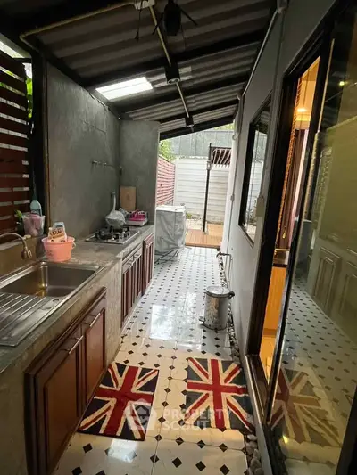 Charming semi-outdoor kitchen with unique flooring and modern amenities, perfect for culinary enthusiasts.
