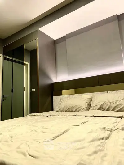 Modern bedroom with stylish decor and ambient lighting, featuring a comfortable bed and sleek design.