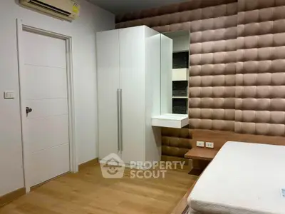 Modern bedroom with stylish wall paneling and sleek white wardrobe
