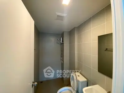 Modern bathroom with sleek design and shower area in a contemporary apartment.