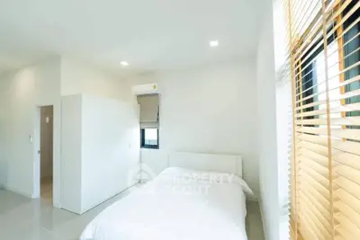 Bright minimalist bedroom with white decor and natural light