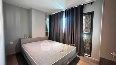 Modern bedroom with large window and stylish curtains, featuring a comfortable bed and sleek flooring.