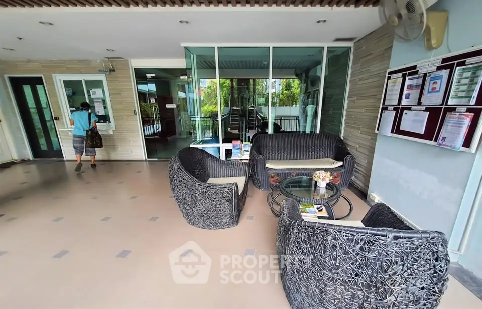 Modern apartment entrance with stylish seating area and glass doors