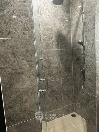 Modern bathroom with sleek glass shower and elegant tile design