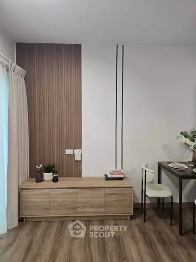 Modern living room with stylish wooden paneling and elegant dining setup