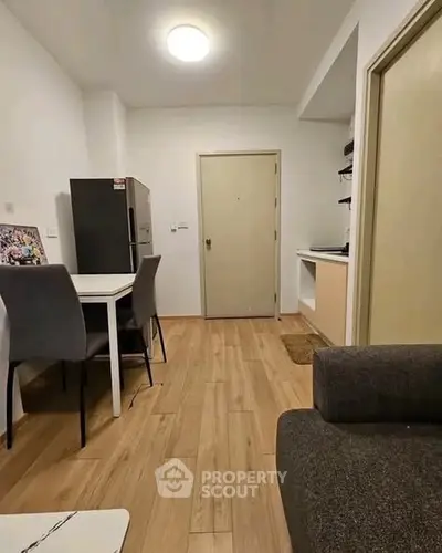 Cozy apartment interior with dining area and modern kitchen setup.