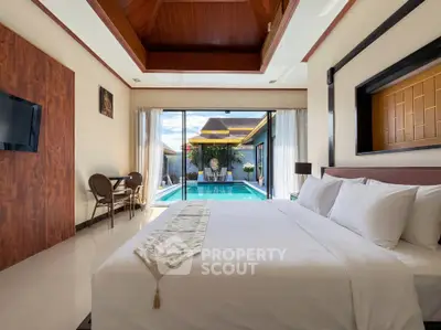 Luxurious bedroom with pool view and elegant decor in a modern villa.