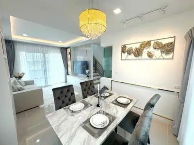 Luxurious open-plan living and dining area with elegant decor and modern furnishings.