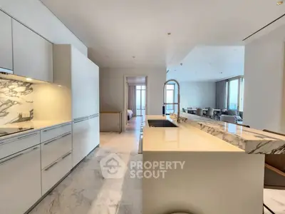 Luxurious open kitchen with marble countertops and modern design in a spacious apartment.