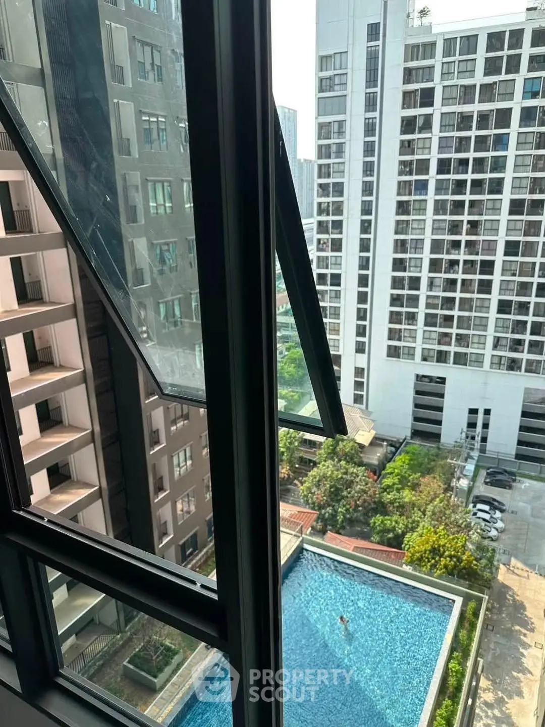 Stunning high-rise view with pool and modern architecture, perfect for urban living.