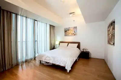 Spacious modern bedroom with large windows and elegant decor