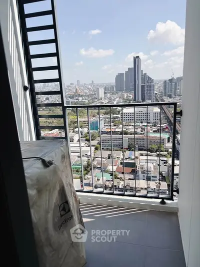 Stunning high-rise balcony view with cityscape and clear blue sky.