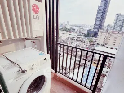 High-rise apartment balcony with city view and washing machine setup.