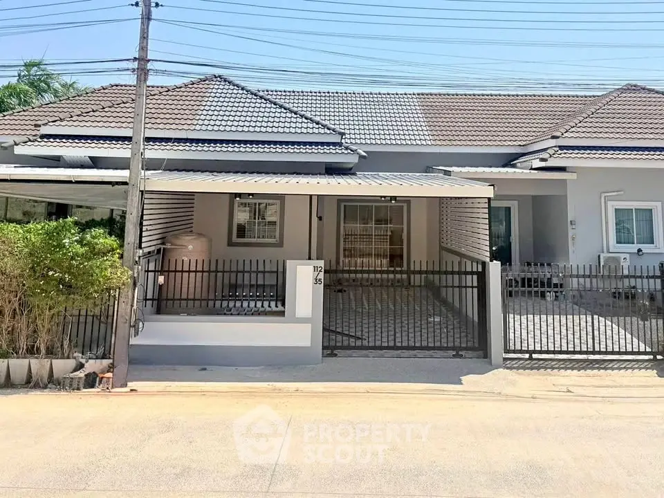 Charming single-story house with modern design and gated entrance in a serene neighborhood.
