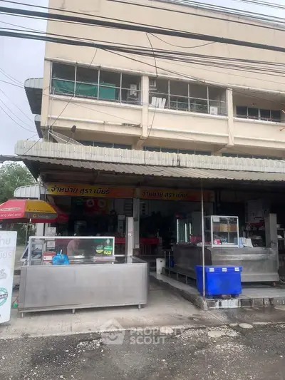 Commercial property with street-facing storefront and ample signage, ideal for retail or restaurant business.