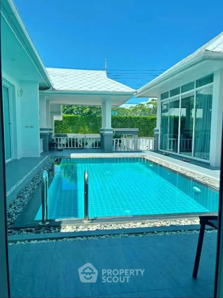 Luxurious villa with private pool and modern architecture under clear blue sky.