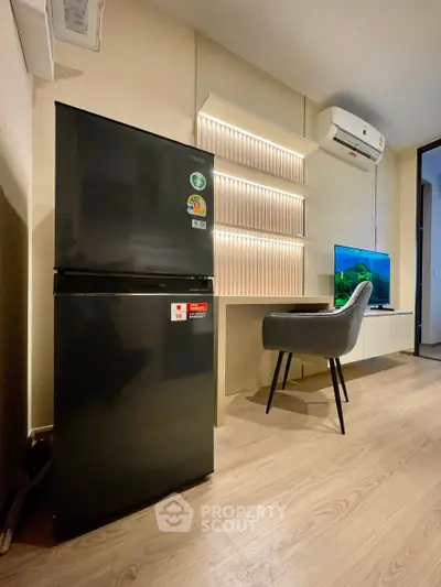 Modern apartment interior with fridge, TV, and stylish chair