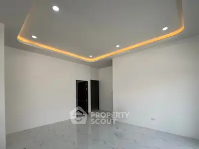 Spacious modern living room with elegant recessed lighting and marble flooring.